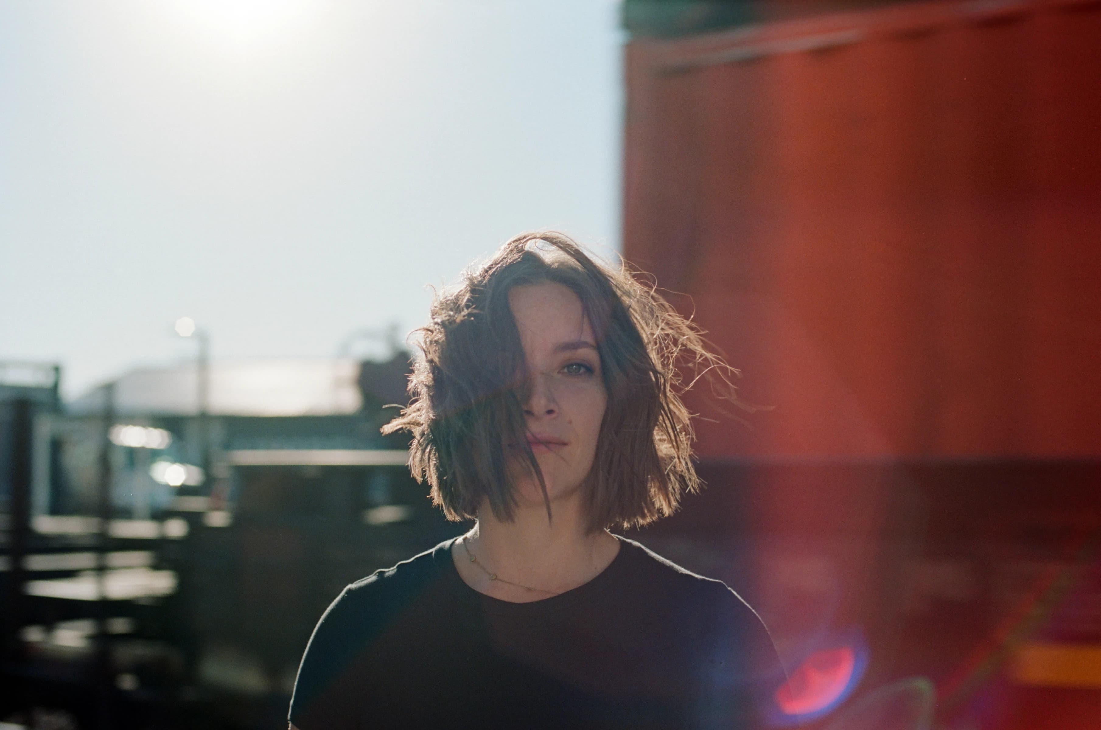 Portrait of Olive with trains moving behind